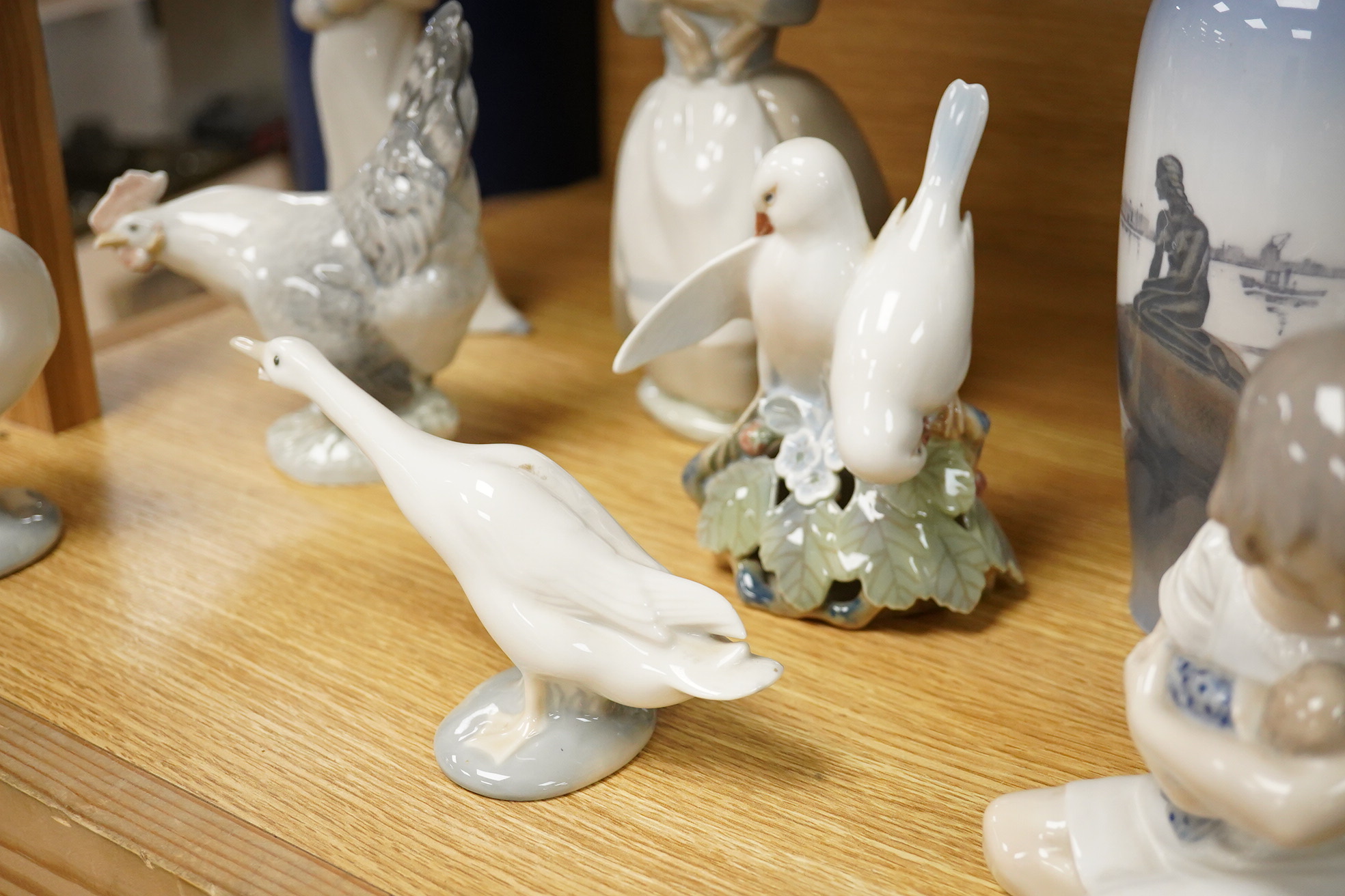 A group of Copenhagen, Nao and Lladro figures to include birds, together with a Royal Copenhagen vase, largest 21cm high
